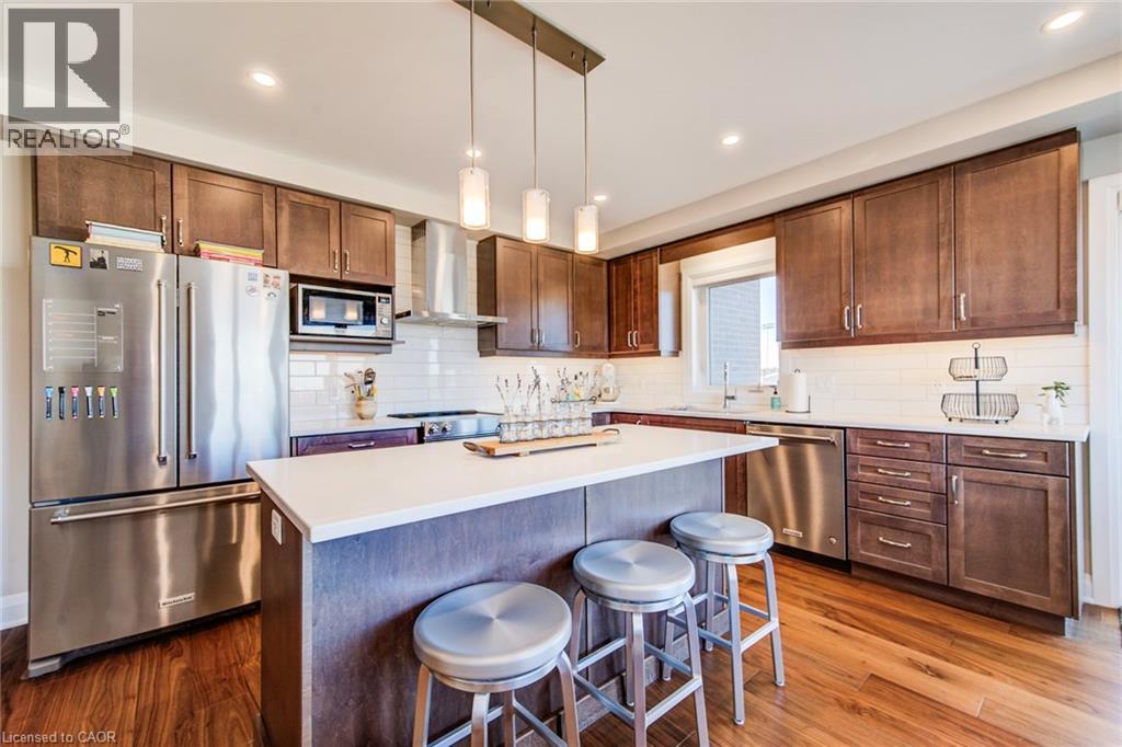 A modern kitchen with wooden cabinets and stainless steel appliances.