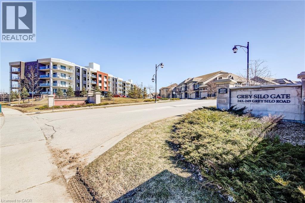 A realtor photo of a residential area with apartment buildings and a sign that reads "Grey Silo Gate".