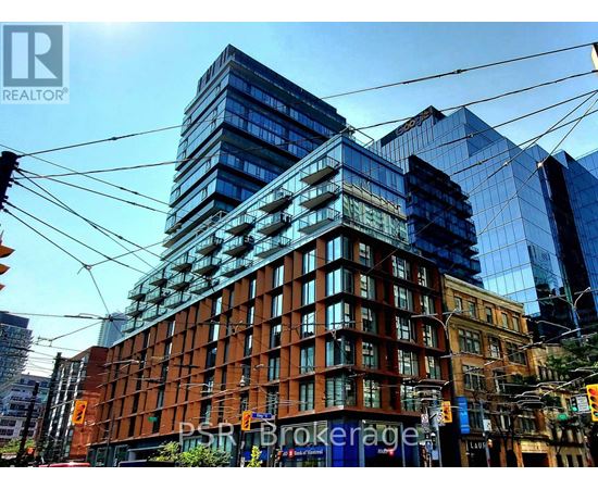 A cityscape with a mix of modern and older buildings, with the sun casting shadows on the scene.