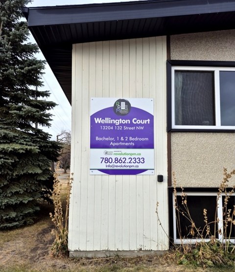 A sign for Wellington Court is posted on a door.