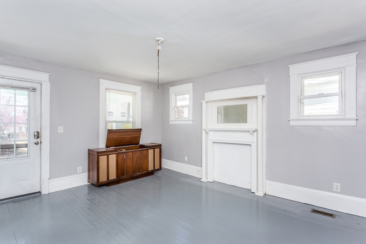 A room with a wooden bench and a window.