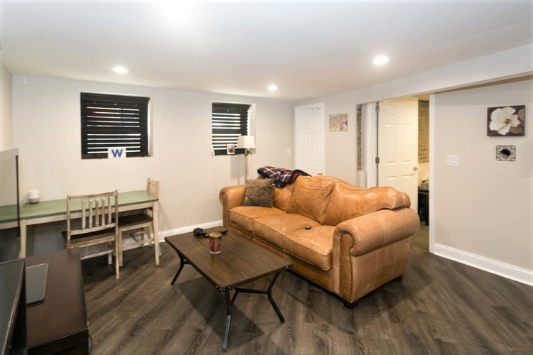 A living room with a tan couch and a coffee table.