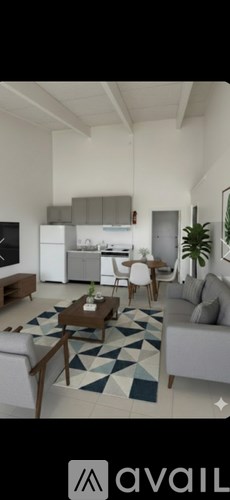 A modern living room with a grey sofa and a coffee table.
