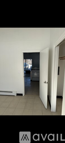 A room with a white door and a window.