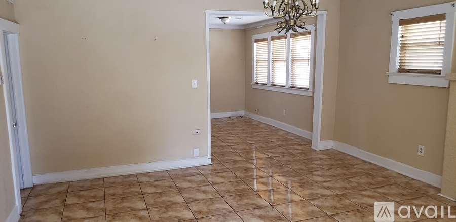 A room with beige walls and tiled flooring is available for rent.