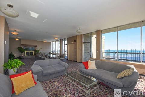 A living room with a grey couch and a coffee table.