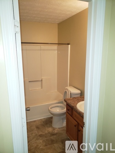 A bathroom with a toilet, sink and bathtub.