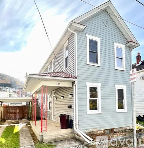 A two-story house with a garage on the ground floor.
