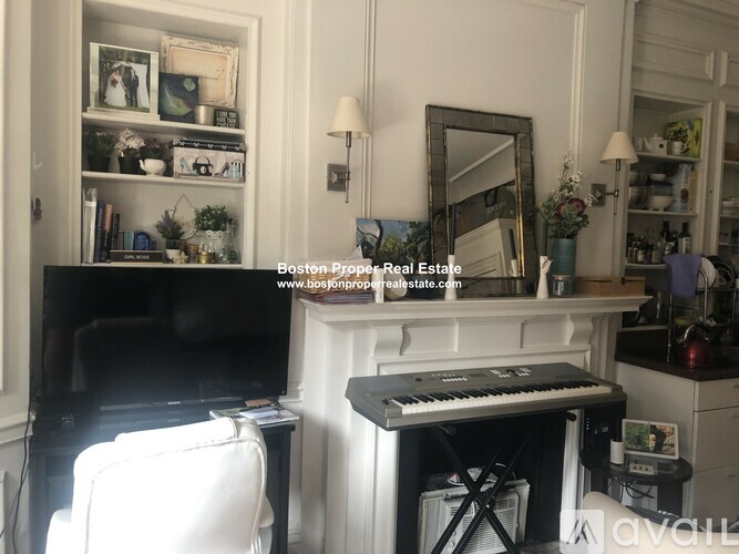 A living room with a piano and a TV.