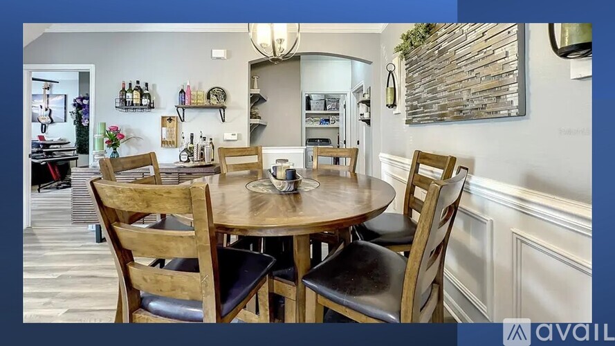 A dining room with a round table and chairs.