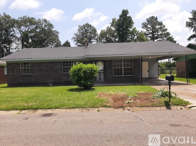 A house with a brick facade and a grey roof is for sale.
