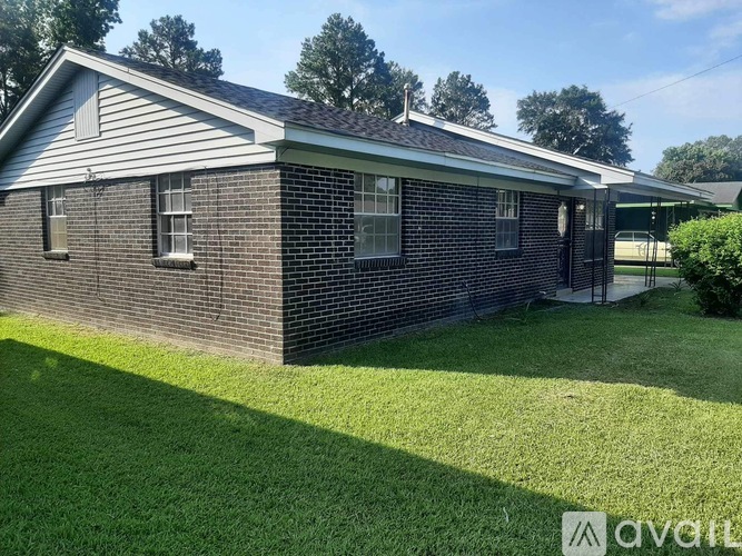 A house with a well-kept lawn in front.