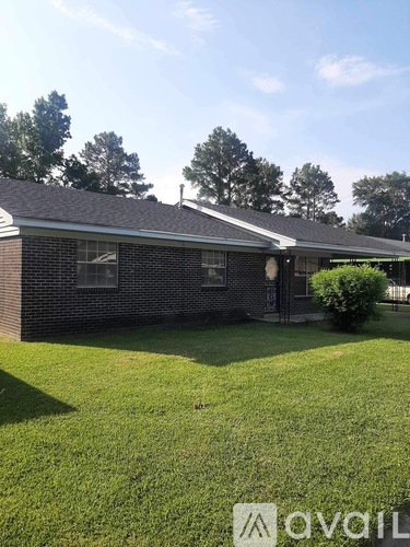 A house with a lawn in front of it.