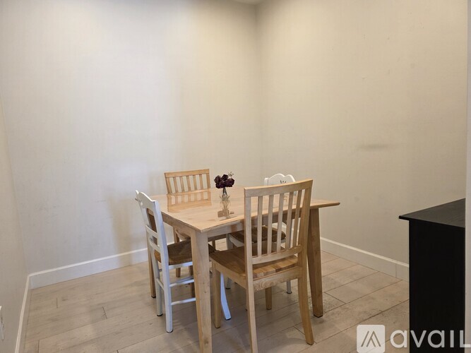 A small table with two chairs in a room.