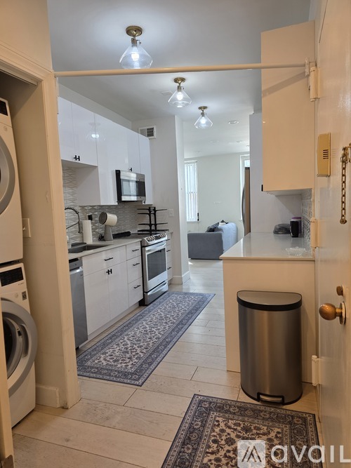 A modern kitchen with a washer and dryer built in.