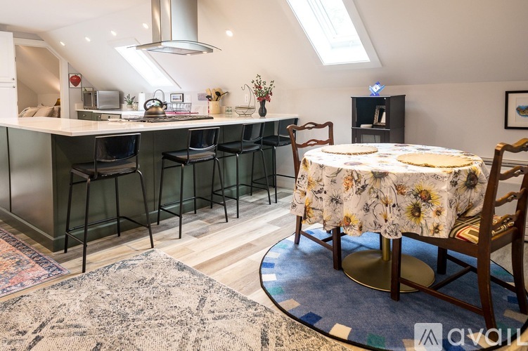 A kitchen with a table and chairs in the middle of the room.