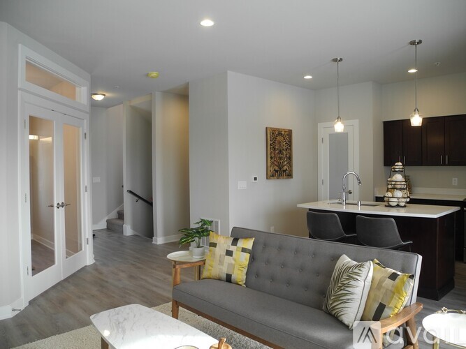 A living room with a grey couch and a coffee table.