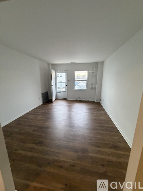 A room with wooden floors and white walls.