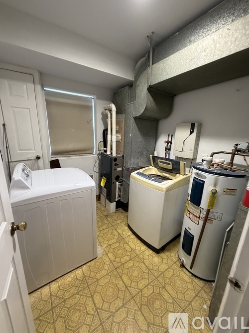 A room with a washer and dryer in it.