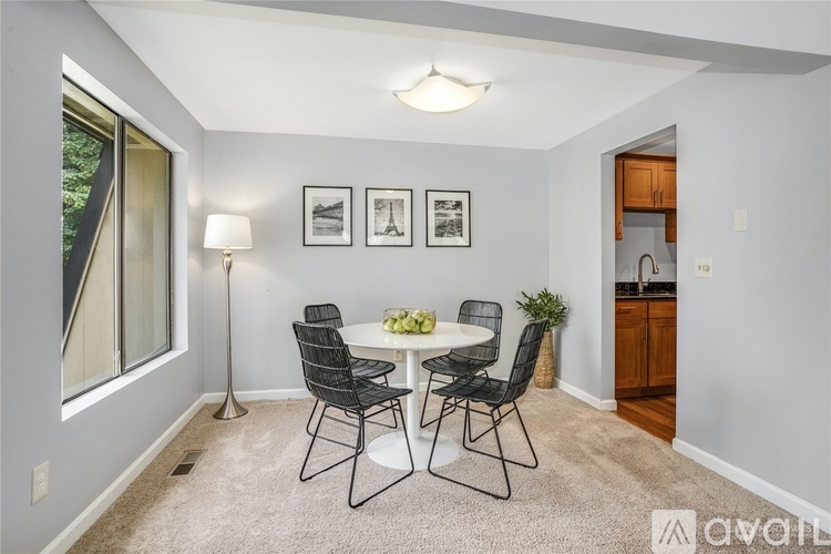 A dining room with a table set for four.