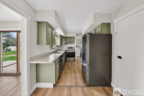 A modern kitchen with a refrigerator on the right.