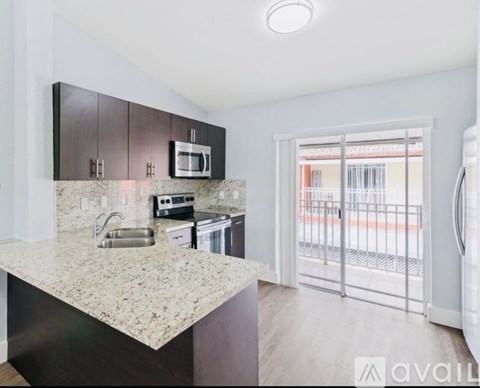 A kitchen with granite countertops and stainless steel appliances.