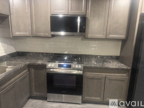 A kitchen with a stove top oven and microwave above it.