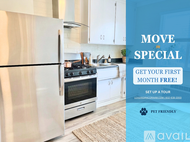 A kitchen with a refrigerator, oven, and sink is on display with an advertisement for a free first month offer.