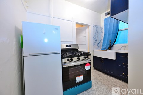 A kitchen with a white fridge and a black stove top.
