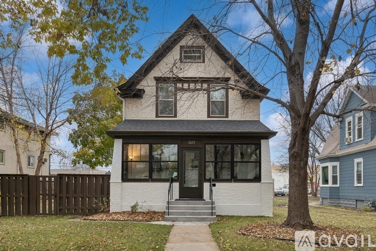 A house with a black front door and a small porch.