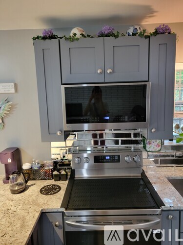A kitchen with a bed in the middle of it.