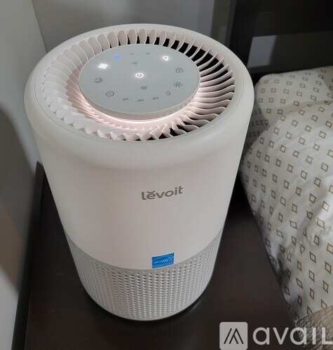 A white L'evot portable air conditioner on a table.