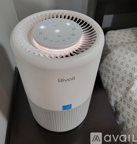 A white L'evot portable air conditioner on a table.