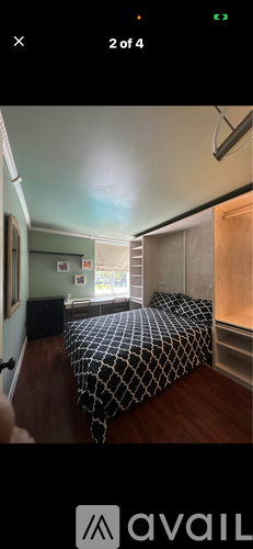 A bedroom with a bed and a window.