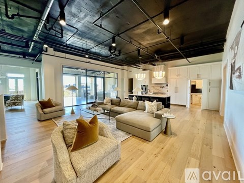 A spacious living room with a large couch and a coffee table.