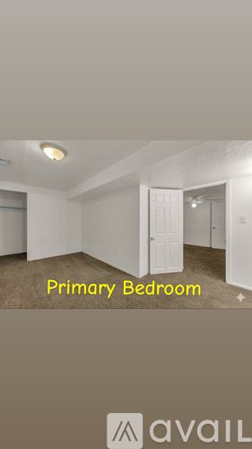 A bedroom with a white door and a carpet on the floor.