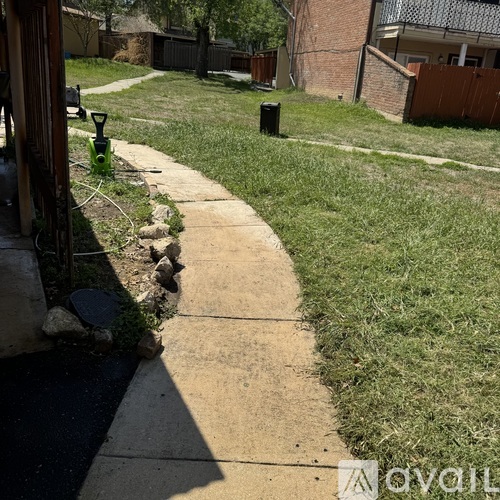A concrete pathway leads through a grassy area.
