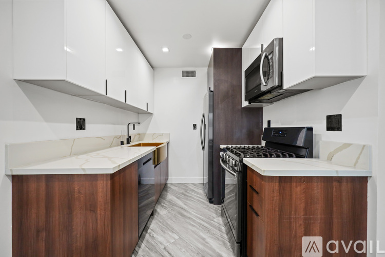 A modern kitchen with dark wood cabinets and a white countertop.