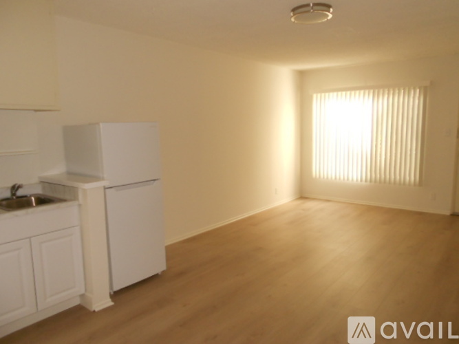 A kitchen with white cabinets and a sink is shown.