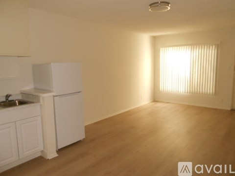 A kitchen with white cabinets and a sink is shown.