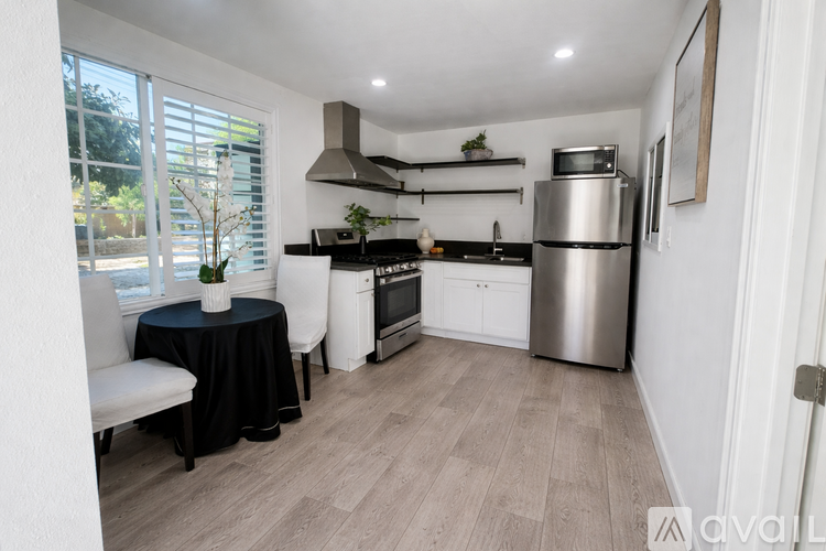 A modern kitchen with a dining table set up.