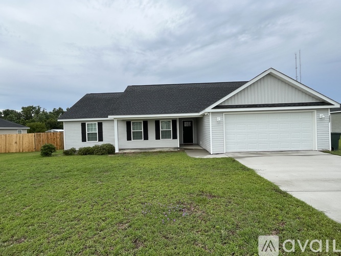 A two-story house with a garage is for sale.