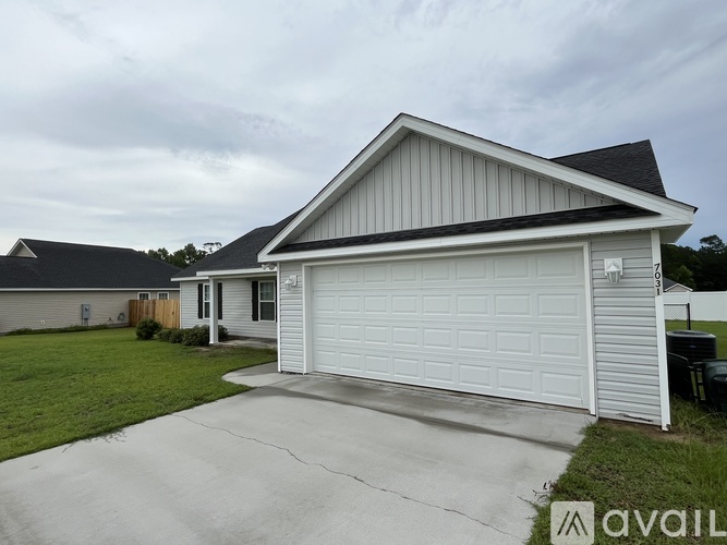A house with a white garage door is for sale.