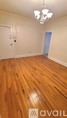 A room with wooden floors and a chandelier.