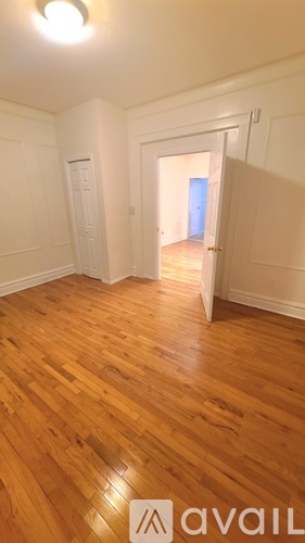 A room with wooden floors and white walls.