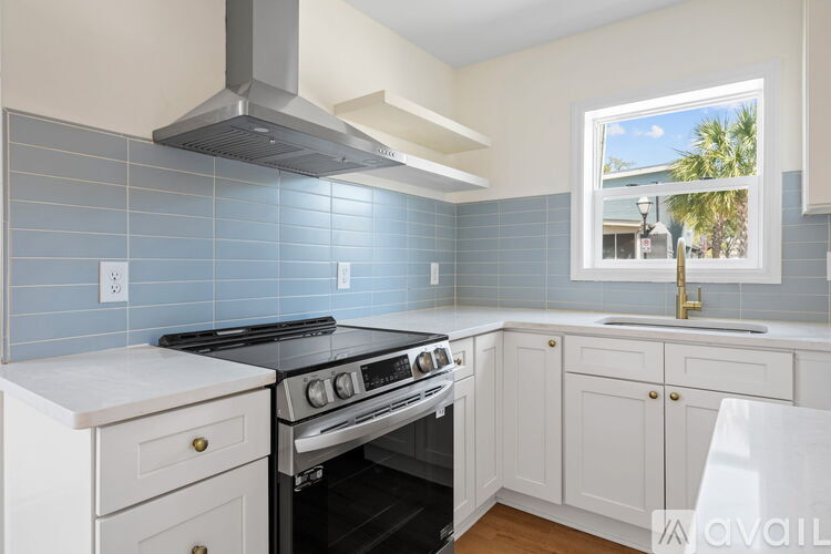 A kitchen with a stove and a window.