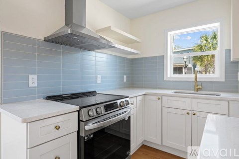 A kitchen with a stove and a window.
