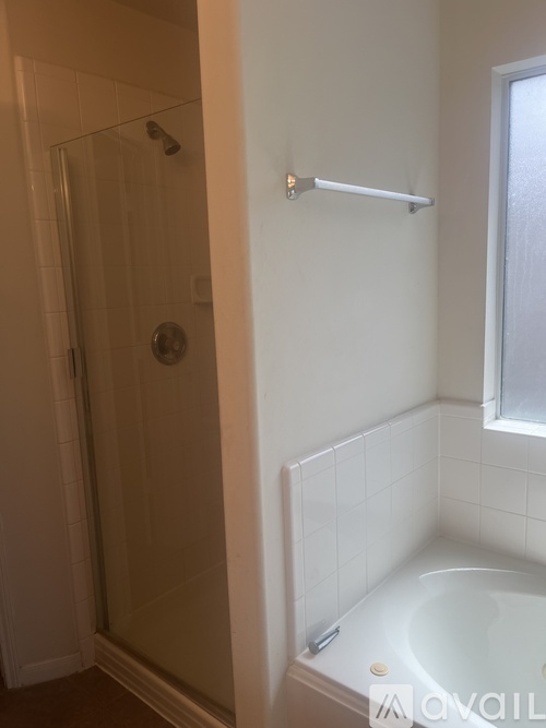 A white bathroom with a tub and shower.