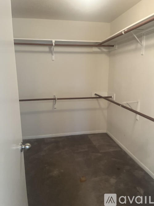 A small, empty room with a door and a shelf.