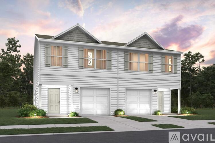 A modern house with a grey exterior and two garages.
